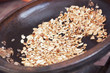 Roasted argan kernels in a frying pan.