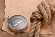 Foto: knot, a compass and a paper on the background of old paper knot, a compass and a paper on the background of old paper