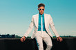 Retro fifties summer fashion man with white suit and sunglasses.