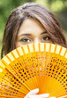 Look young woman with fan.