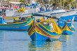 Traditional Luzzu boat at Marsaxlokk harbor in Malta.