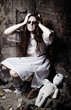 Horror style shot: strange crazy girl and her moppet doll