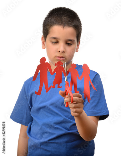 Photo: Divorce concept with sad kid cutting paper family Divorce concept with sad kid cutting paper family