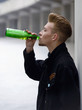 man drinking beer from the bottle