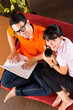 Asian couple on the couch with a laptop