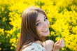 Cheerful girl with a yellow flower