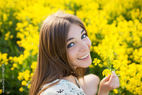 Photo: Cheerful girl with a yellow flower Cheerful girl with a yellow flower