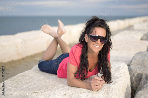 Photo: Beautiful Woman with Sunglasses at the Beach Beautiful Woman with Sunglasses at the Beach