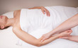 Therapist doing therapeutic deep tissue massage on muscles of a