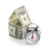house made of dollars and alarm clock.