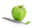Green apple and dental tools isolated on white