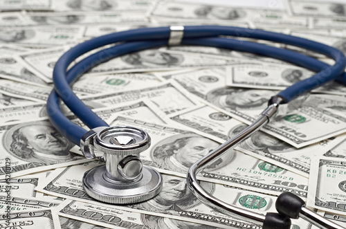 Photo: heap of dollars with stethoscope heap of dollars with stethoscope