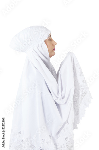 Photo: Close-up of muslim woman praying on white background Close-up of muslim woman praying on white background