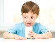 Cute little boy with a glass of milk