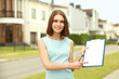 Female architect standing with folder