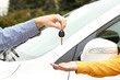 Photo: Woman and man hands with car key, close up Woman and man hands with car key, close up
