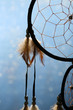 Beautiful dream catcher on blue background with lights