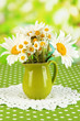 Beautiful bouquet chamomiles in pitcher