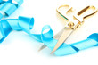 Satin ribbon curled around scissors isolated on white