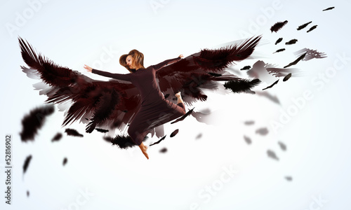 Photo: Woman floating on dark wings Woman floating on dark wings