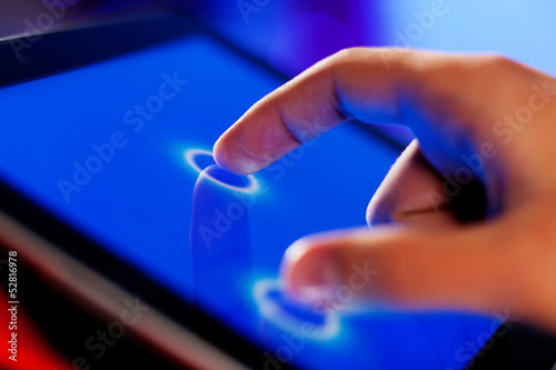Photo: Finger touching screen Finger touching screen
