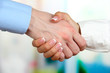 Photo: Business handshake on bright background Business handshake on bright background