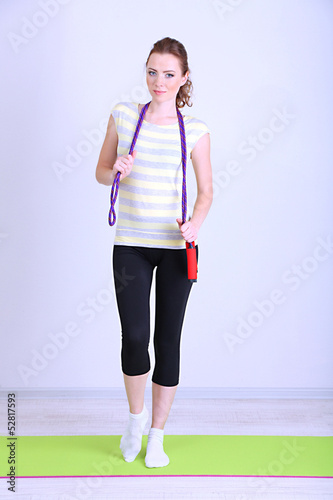 Photo: Beautiful young woman with skipping rope Beautiful young woman with skipping rope