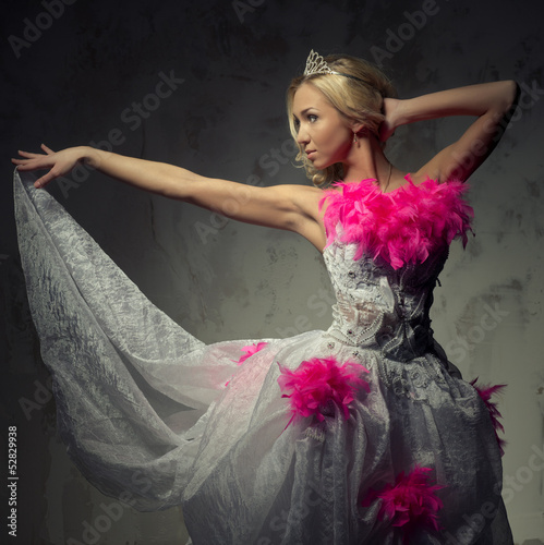 Photo: Lovely woman wearing white dress decorated with pink feather boa Lovely woman wearing white dress decorated with pink feather boa