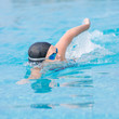 Woman in goggles swimming front crawl style