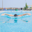 Young girl swimming butterfly stroke style