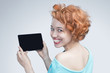 Red-haired girl holding a tablet computer
