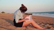 Video: Pretty businesswoman working with documents on the beach Pretty businesswoman working with documents on the beach
