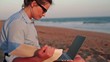Video: Businesswoman working with documents and laptop on the beach Businesswoman working with documents and laptop on the beach