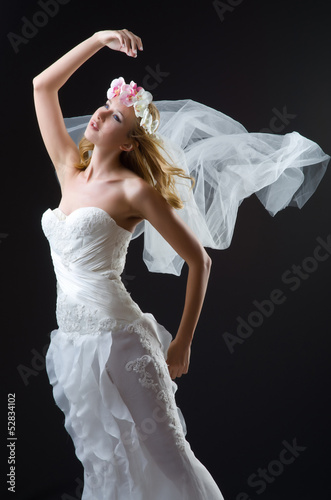 Photo: Woman in wedding dress dancing Woman in wedding dress dancing