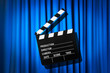 Movie clapper board against curtain