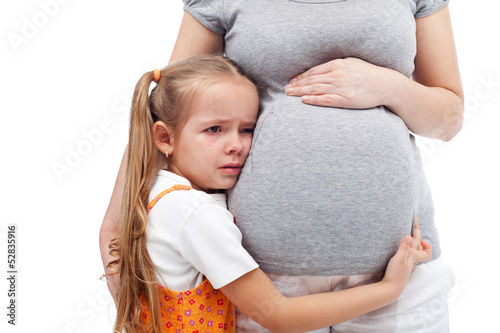 Photo: Spoiled little girl not happy about her coming sibling Spoiled little girl not happy about her coming sibling