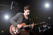 Man playing guitar during concert