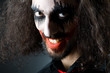 Joker personification with man in dark room