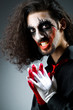 Joker personification with man in dark room