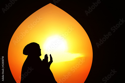 Photo: Beautiful orange silhouette of muslim praying at mosque Beautiful orange silhouette of muslim praying at mosque