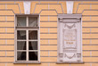 A window with a memorial plate.
