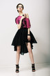Tendency. Fashion Model in Modern Clothes posing in Studio