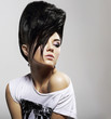 Updo Hair. Woman with Trendy Hairstyle with Diamond Earrings