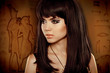 Foto: Hair. Beautiful Brunette Girl over Egyptian hieroglyphs Hair. Beautiful Brunette Girl over Egyptian hieroglyphs