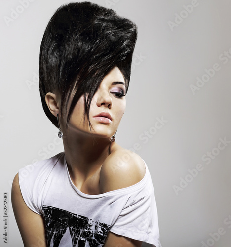 Photo: Updo Hair. Woman with Trendy Hairstyle with Diamond Earrings Updo Hair. Woman with Trendy Hairstyle with Diamond Earrings