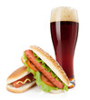 Photo: Dark beer glass and two hot dogs with various ingredients Dark beer glass and two hot dogs with various ingredients