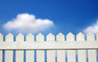 grass and white picket fence