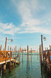 Pier for gondola boats at canal in Venice. Italy.