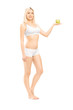 Beautiful woman in white cotton underwear holding a green apple