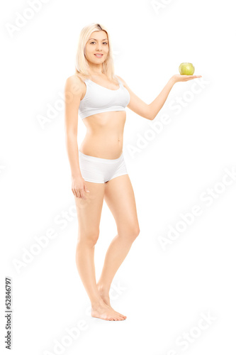 Photo: Beautiful woman in white cotton underwear holding a green apple Beautiful woman in white cotton underwear holding a green apple